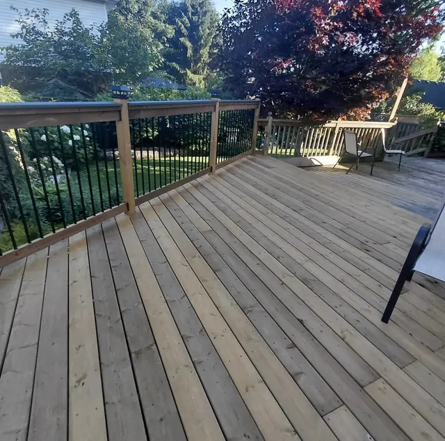 Wood deck with black metal railing, built in London, Ontario