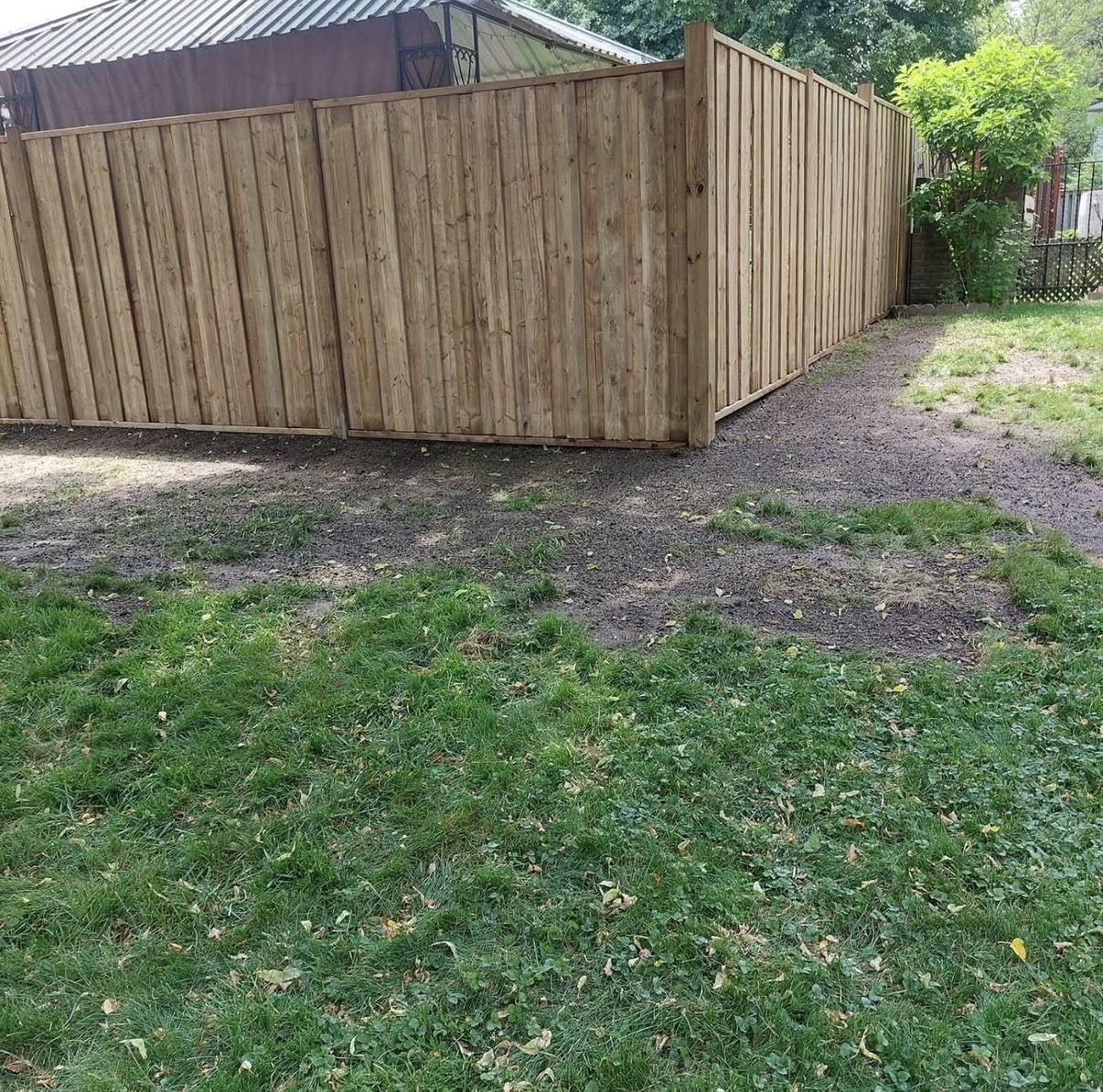 Wood privacy fence built around a backyard gazebo