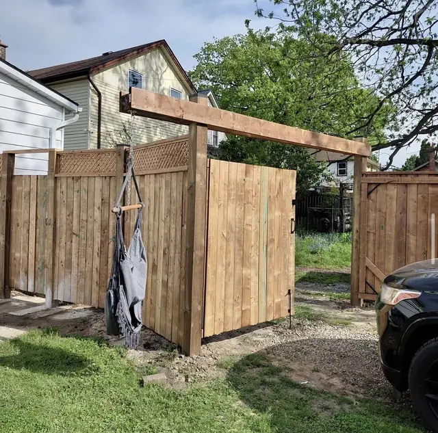 Wood side gate with an arbour overhead, built in St. Thomas