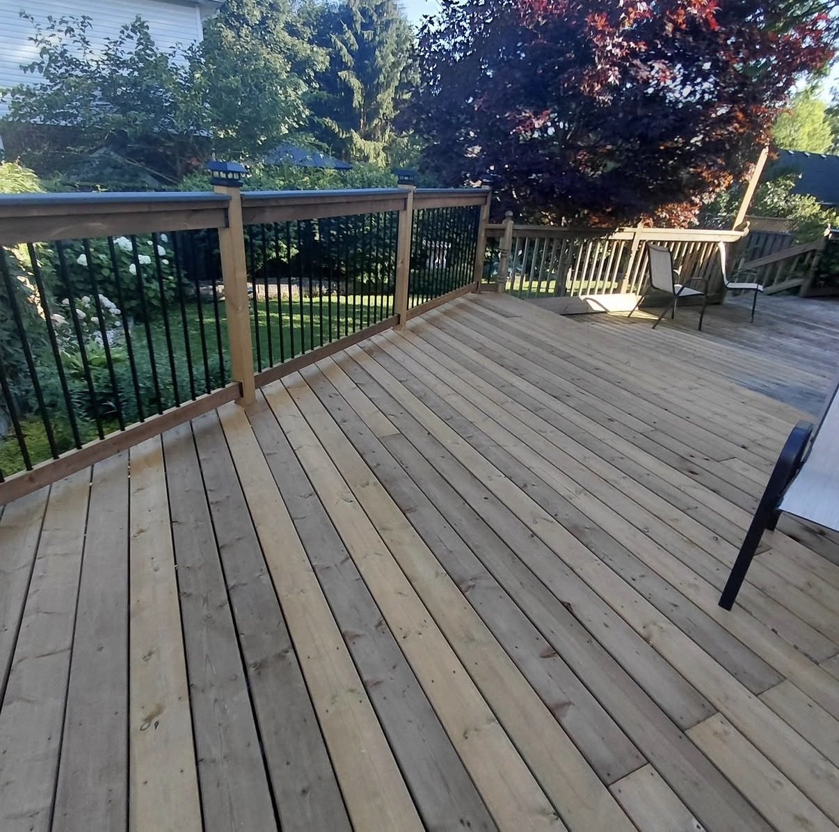 Backyard deck with black metal railing