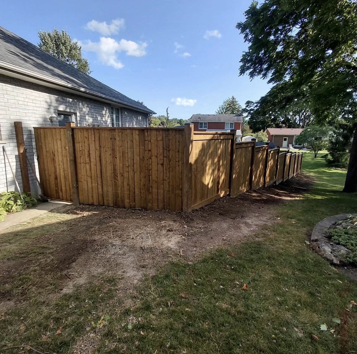Freshly stained wood privacy fence